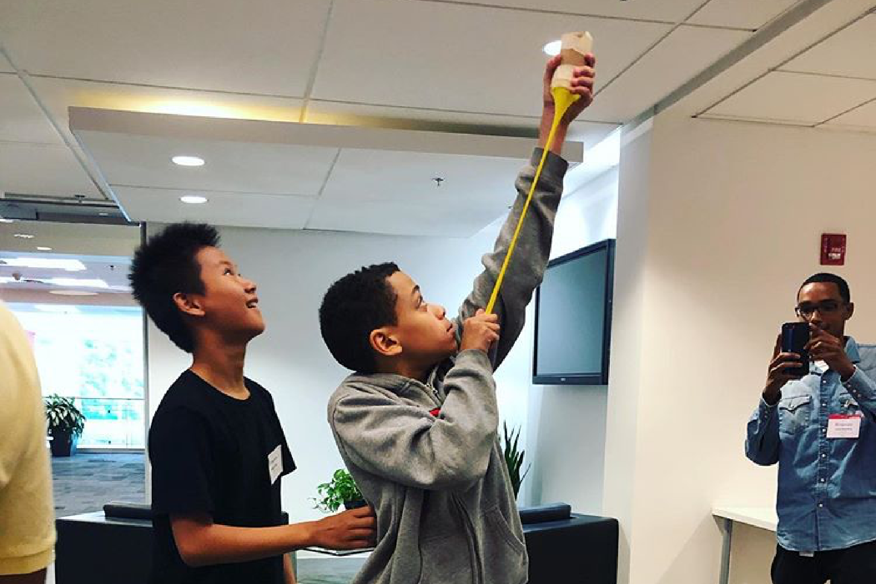 Image of two boys doing a science experiment in the Imprivata office