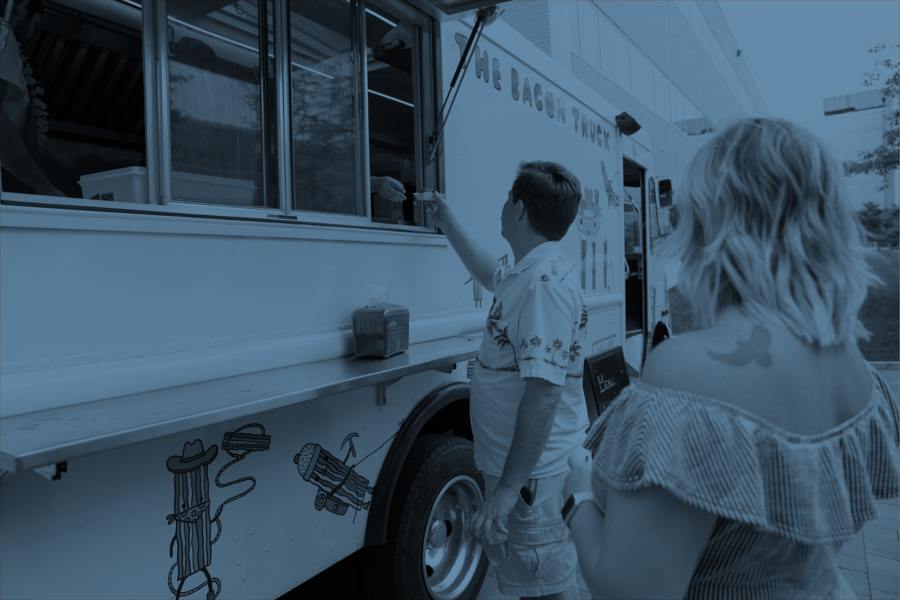 Image of an employee being handed food from a food truck window