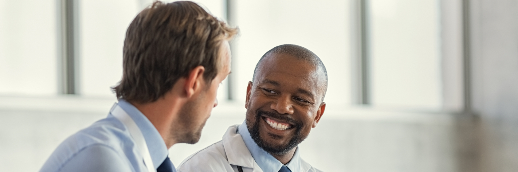 Image of a businessman and a doctor talking with each other 