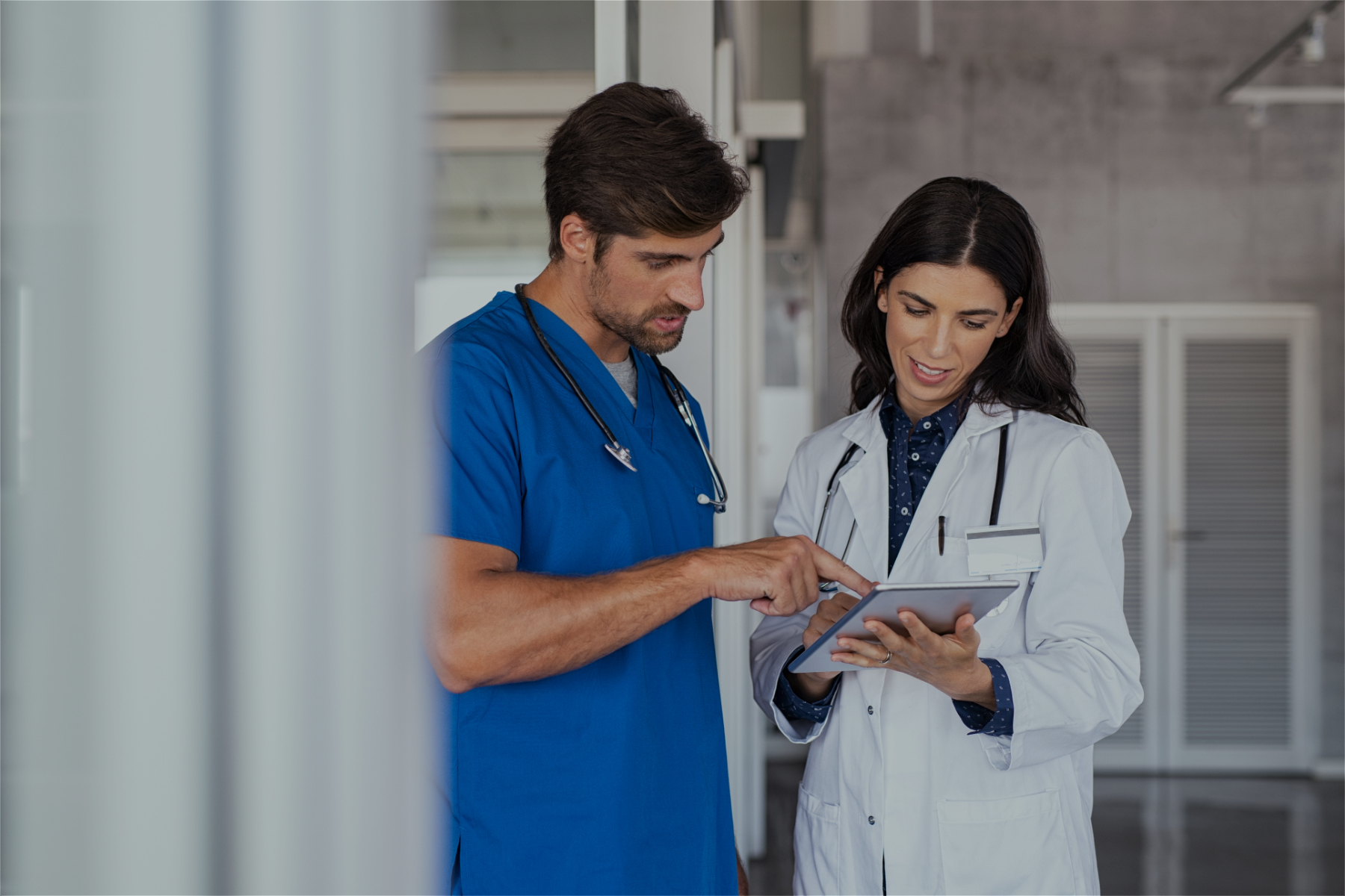 Image of a doctor and a nurse looking at a smart tablet