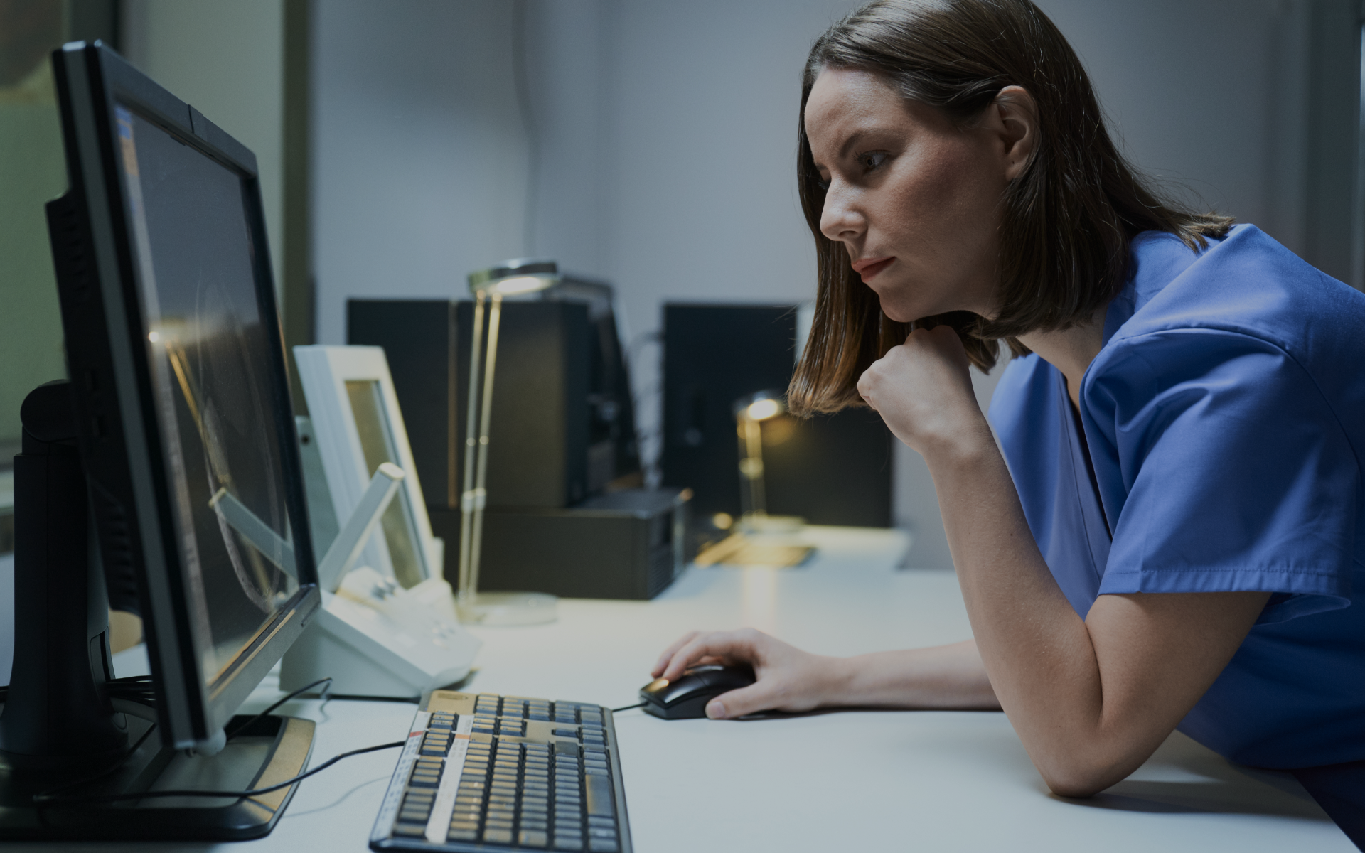 Nurse looks at computer screen