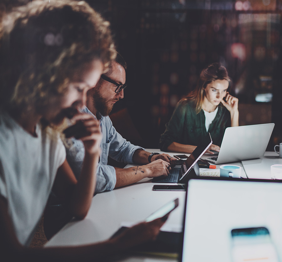 Image of people working on devices