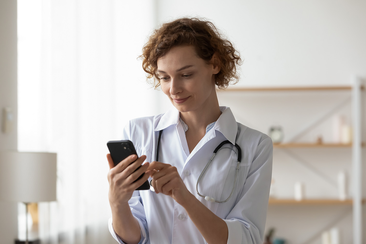Image of a doctor viewing a mobile device