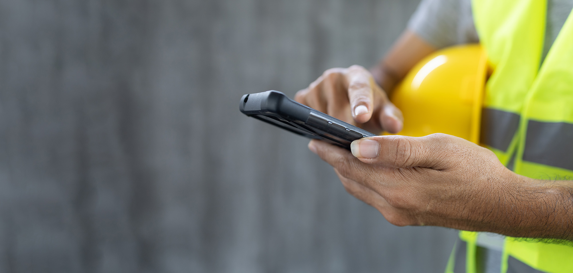 Construction worker using mobile device