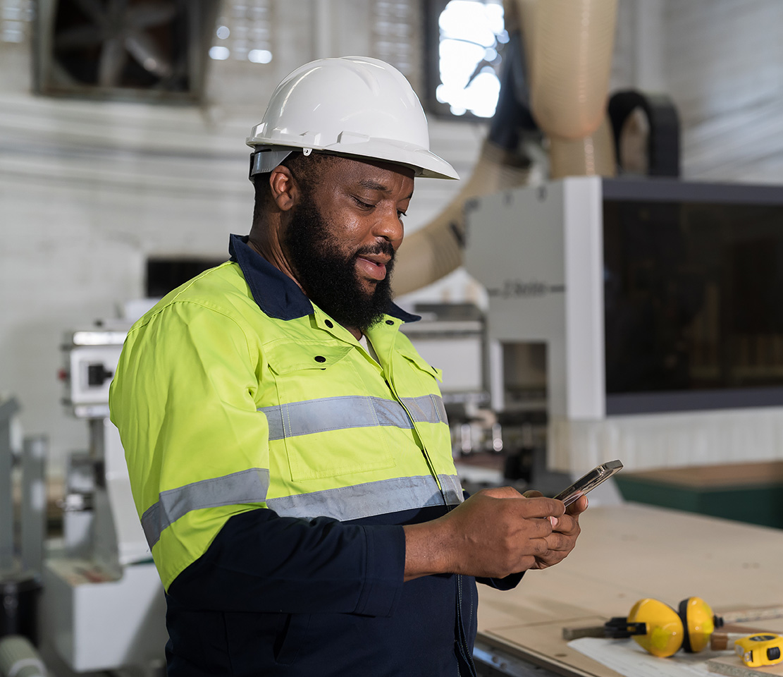 Manufacturing professional with mobile device