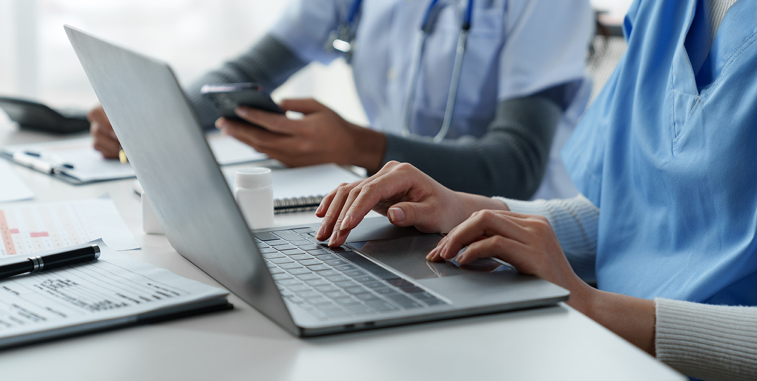 Clinicians with laptop and phone