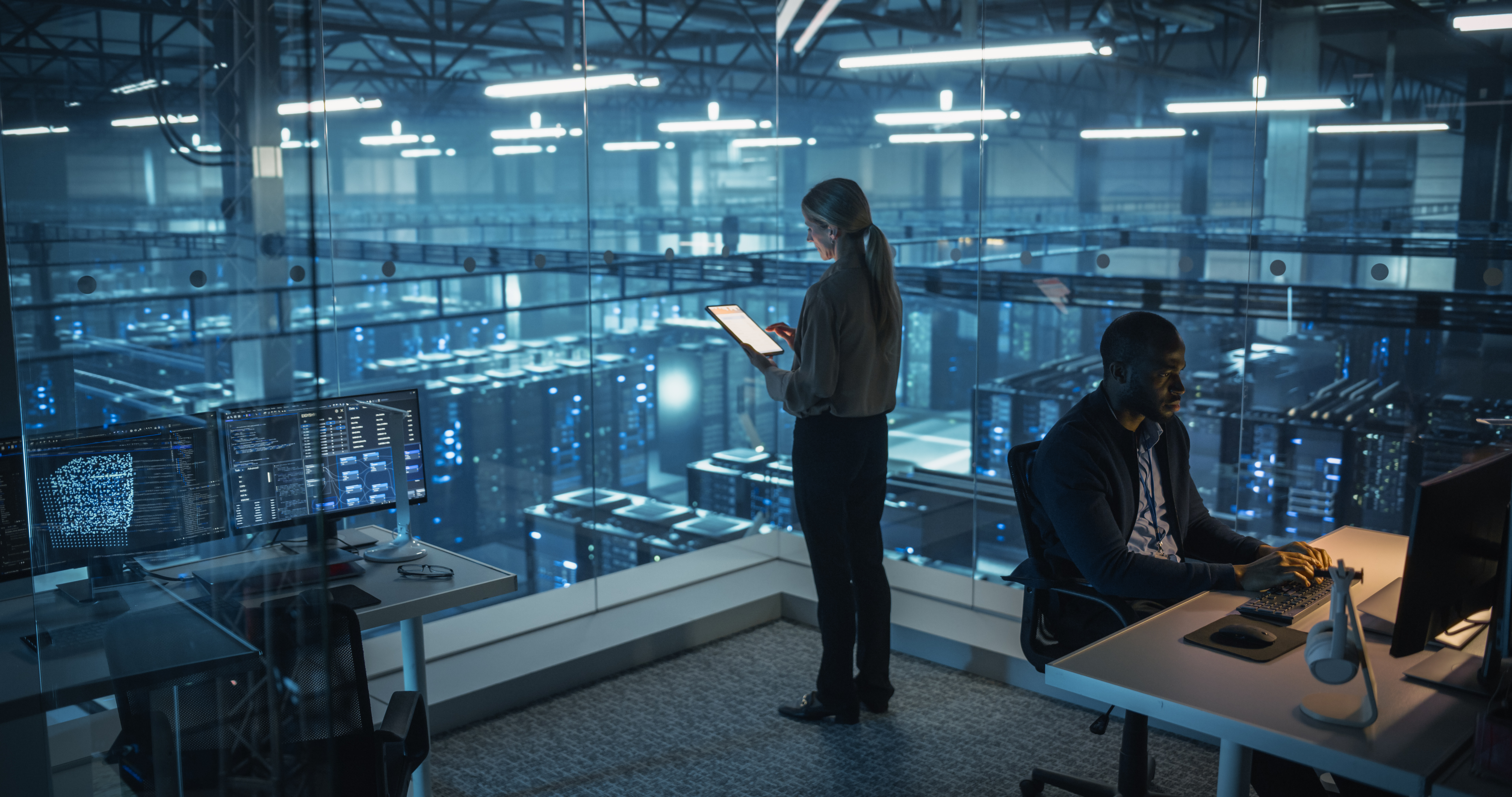Female Information Technology Engineer Reviews Security Logs on Her Tablet Computer in a High-Tech Data Center, Analyzing Potential Risks to Ensure Network Safety
