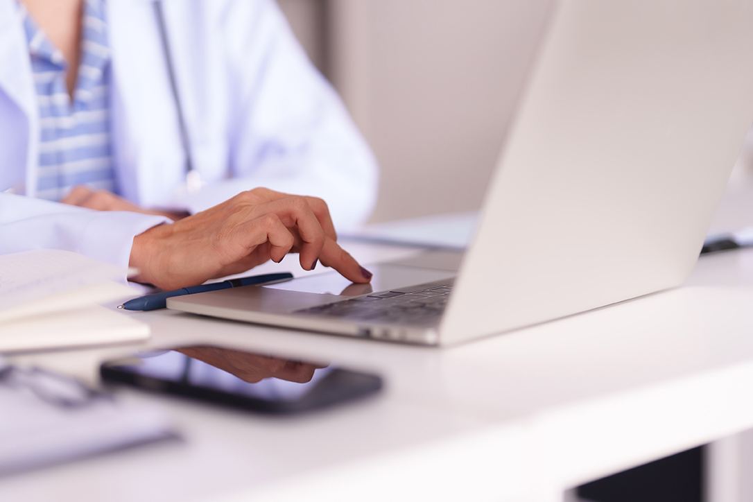 Medical professional using digital tools to access workstation