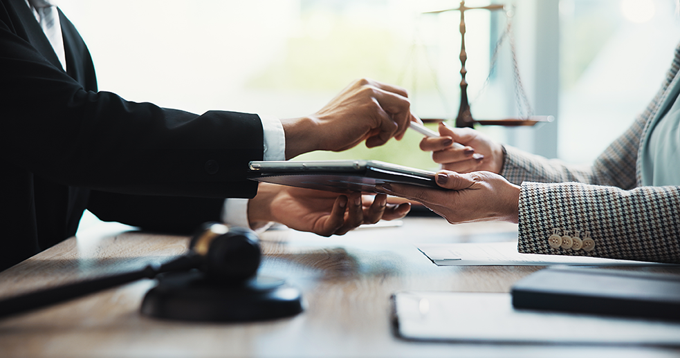 Hands, people and meeting with tablet, legal office and contract review for company compliance. Attorney, lawyer and tech for consultation, digital document and e signature at corporate law firm