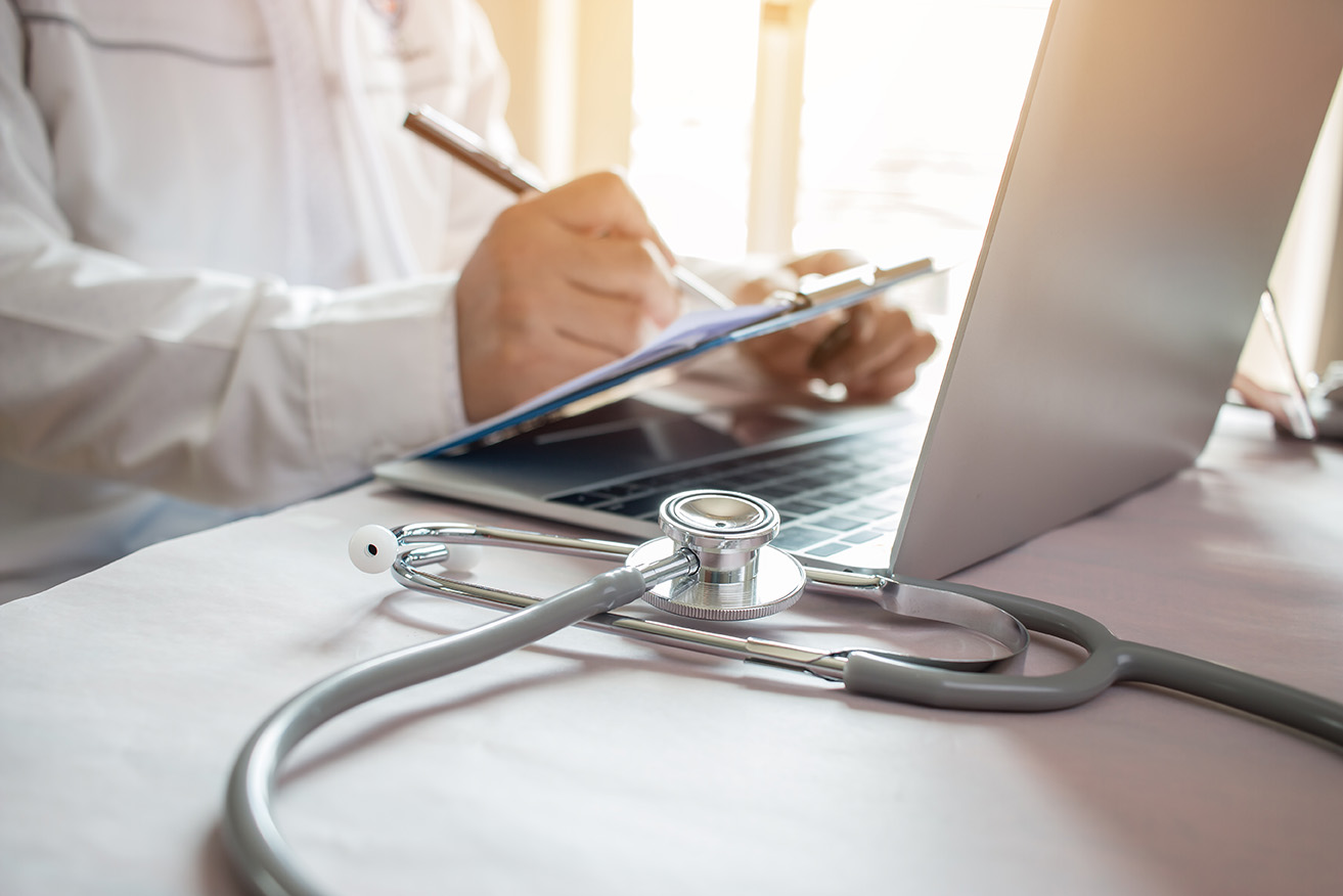 Clinician accessing laptop