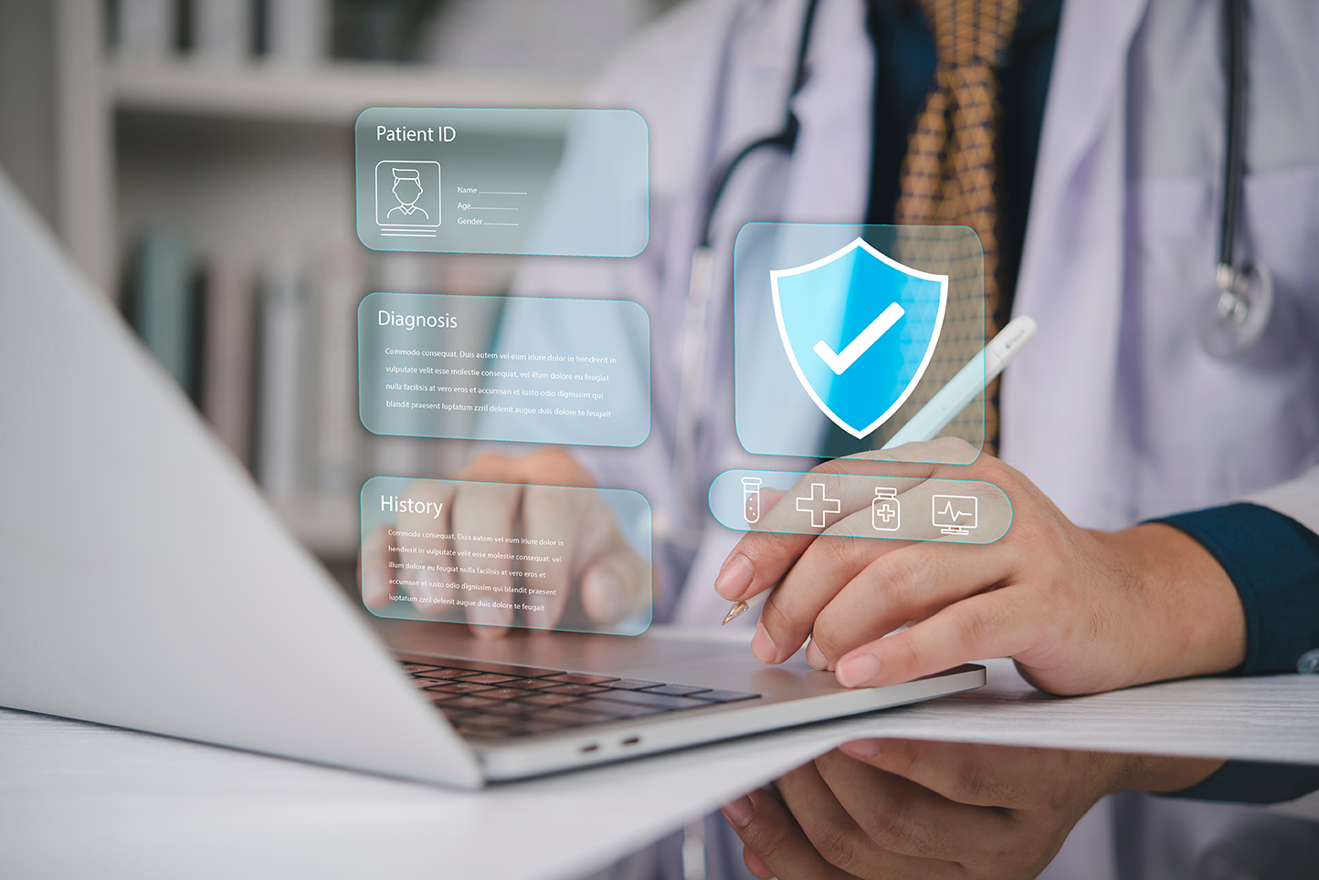 Healthcare professional using a laptop with digital patient information and security icons displayed on screen.