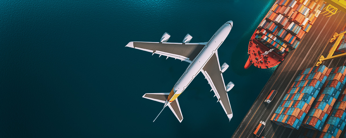 Airplane over cargo ships