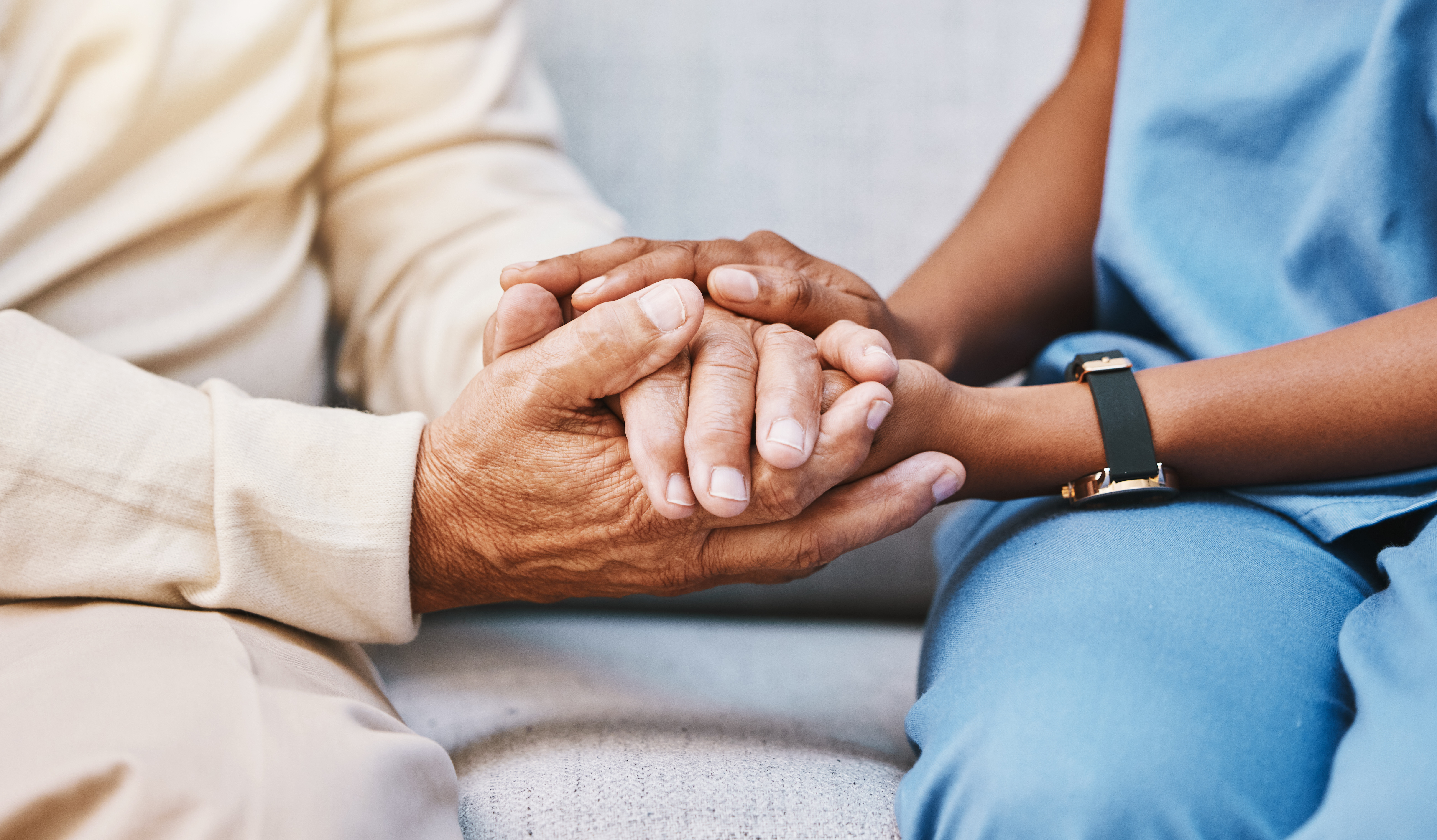 Nurse holding a patient's hand