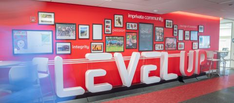 Image of large foam letters in an office hallway that read 'LEVEL UP'