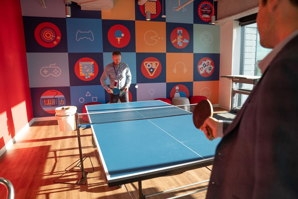 Image of our employees playing ping pong