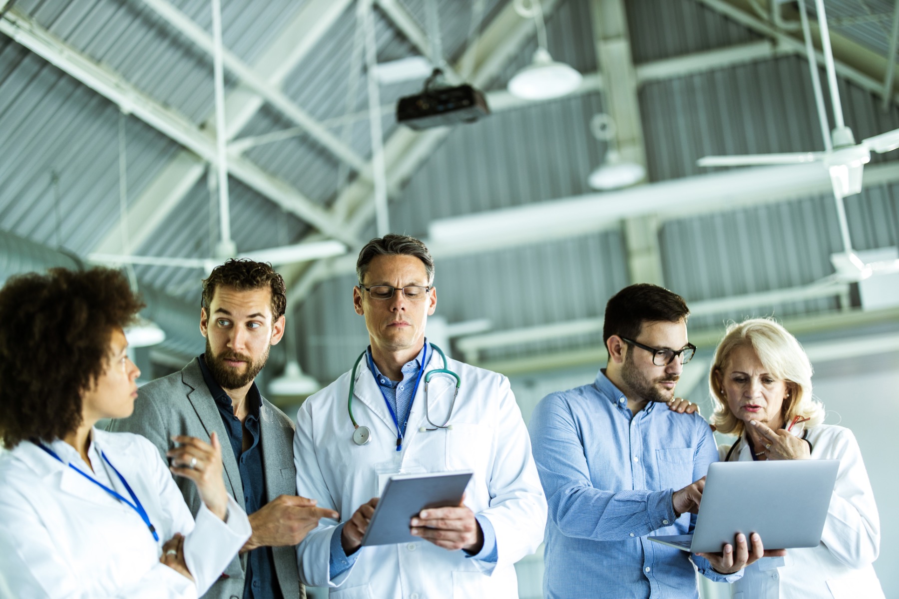 Researchers in lab coats examining results.